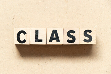 Alphabet letter block in word class on wood background