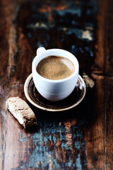 Cup of coffee and Cantuccini (Italian cookie) on dark wooden background. Copy space.