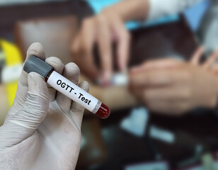 Doctor holds blood sample for Oral Glucose Tolerance Test (OGTT). Three or Five Sample testing for...