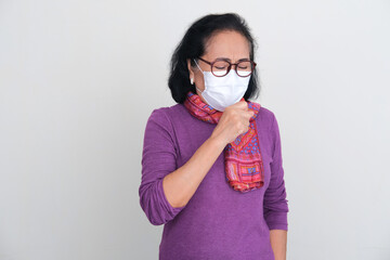 Asian elderly women wearing medical mask while get cough