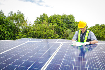 Asian male electrical engineer Supervise and supervise the installation of solar cell systems for...