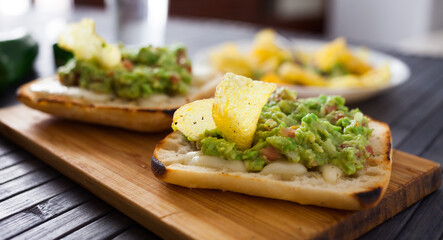 healthy breakfast. toasted italian ciabatta bread with melted cheese and avocado puree