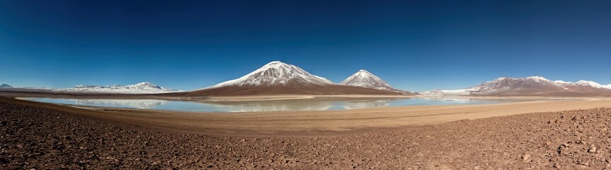 Stunning snow capped mountain landscape at Bolivian Altiplano. Mountains reflecting in the lake in Bolivia. Panoramic view of Bolivian Altiplano