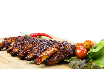 Grilled pork ribs on a wooden cutting board.