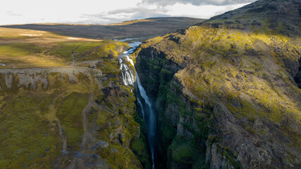  Glymur Waterfall canyon with  Hvalfell mountain peak covered with snow