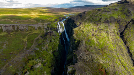  Glymur Waterfall canyon with  Hvalfell mountain peak covered with snow