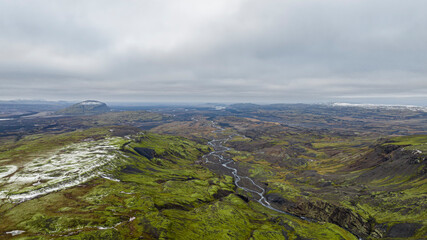 aerial view on green iceland landscape with snow