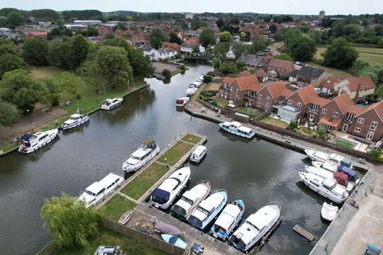 Boats moored Beccles town in Suffolk UK drone aerial view