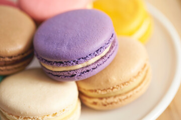 colorful macaroons on wooden table	