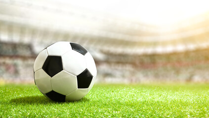 Soccer ball on the grass in a soccer stadium