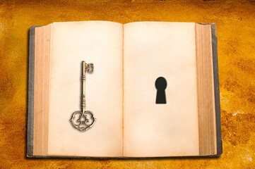 open book with blank pages and a key and a keyhole