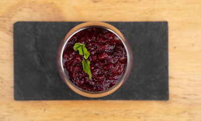 Desserts. Top view of chocolate pudding with red berries puree, served in a glass. 