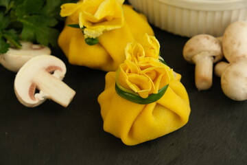 Pancakes. Yellow stuffed bliny with mushrooms and sour cream. Light background. Beautiful and...