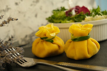 Pancakes. Yellow stuffed bliny with mushrooms and sour cream. Light background. Beautiful and...