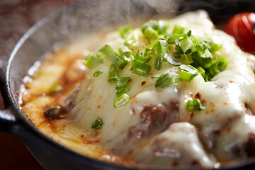 Close-up of melted cheese on an iron plate