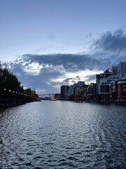Naklejka premium Modern buildings by the waterfront at twilight. Taken in Salford Quays England. 