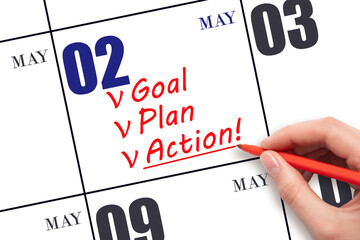 Hand writing text GOAL PLAN ACTION on calendar date May 2. Motivation for a new day. Business...