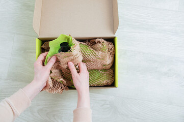 Unpacking  parcel. Open cardboard box on a white wooden floor.