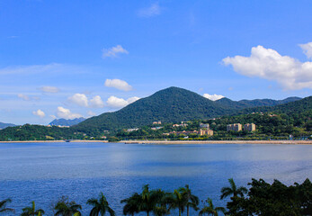 A beautiful scene of a seascape and mountains under the clear blue sky