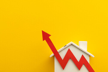 Rising cost of living. Mortgage inflation rates increase. House with a red up arrow