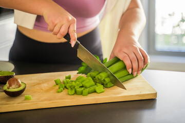 Cropped view of caucasian lovely woman chef preparing vegetables for the future salad