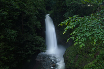 waterfall flowing down the mountain