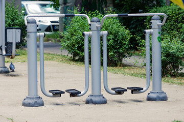 Public park grey workout machines or equipment to stay active and train muscle