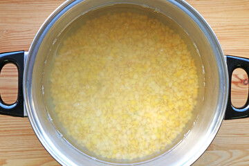 Soaking dehulled soybeans in water overnight for making Tempeh
