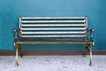 field bench, outdoor chair made of steel with backrest The backdrop is a green cement wall. Soft...