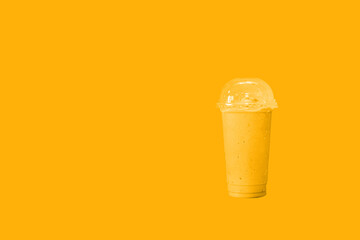 orange smoothie in takeaway cup.