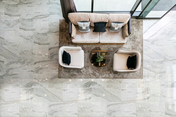 Birds eye view,  a scene at local condo where people relax by sitting on couch