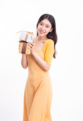 A woman in a yellow dress with a gift box