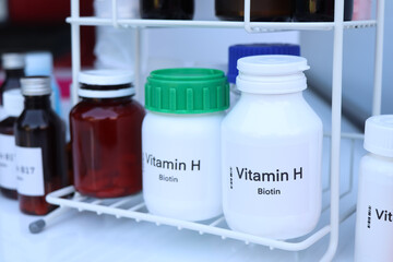 Vitamin H pills in a bottle, food supplement for health