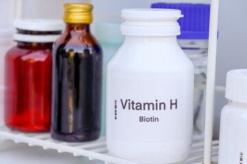 Vitamin H pills in a bottle, food supplement for health