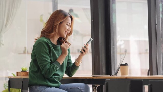 Portrait of an Asian woman holding a smartphone, typing messages, chatting with friends. on social networks mobile application concept Shopping online, browsing the web, ordering food