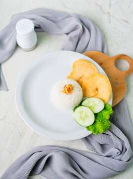 Cooked white rice on plate and white background