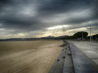 Dramatic sky announcing the arrival of rain in autumn with mysterious rays of light
