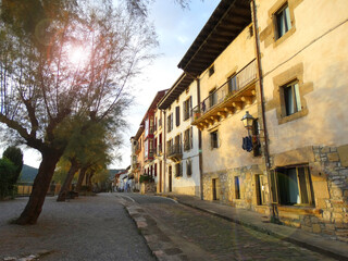 Fototapeta na wymiar Sunset on a picturesque street next to the medieval fortress in Hondarribia Charming Village in Basque Country close to France