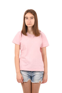 Young beautiful girl in a pink t-shirt and denim shorts on a white background