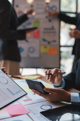 Business people in a meeting and using a calculator to calculate, plan, analyze, create graphs and charts to show business growth to plan new business expansions in the future.