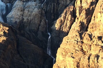Fototapeta na wymiar Waterfall beside Crowfoot Glacier near Bow Lake
