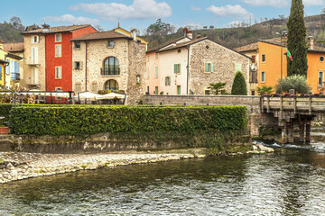 Fototapeta na wymiar The beautiful colored houses of the hamlet of Borghetto sul Mincio reflecting on the water