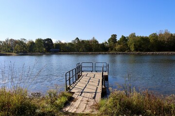 The old wood dock at the lake on a sunny day.