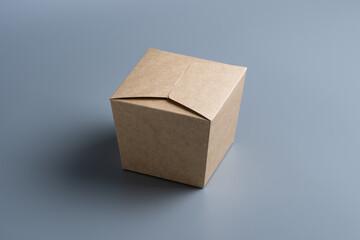 Closed cardboard box on grey background.