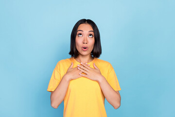Photo of excited impressed gorgeous girl with bob hairstyle wear yellow t-shirt look empty space sale isolated on blue color background
