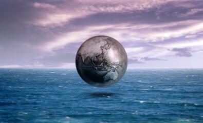 Obraz na płótnie Canvas Iron earth globe above the ocean