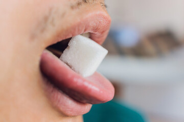 Man and sugar. Calories. Sugar free. tongue close-up.