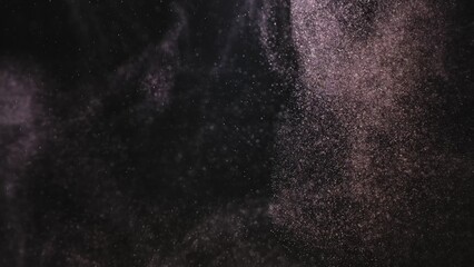 Cloud of floating dust particles shimmering in rays of studio light on black background. Macro shot of texture whites snow, smoke, steam, fog with glare luminosity.