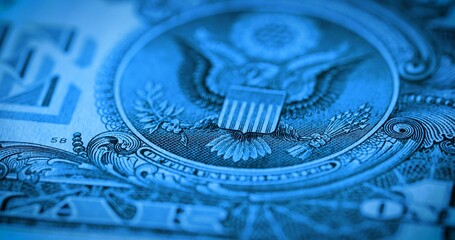 Back side of paper dollar bill with eagle emblem in soft focus. One dollar banknote. Macro shot of american dollar. American currency, greenback, cash. Money background in blue tint.