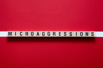Microaggressions word concept on cubes